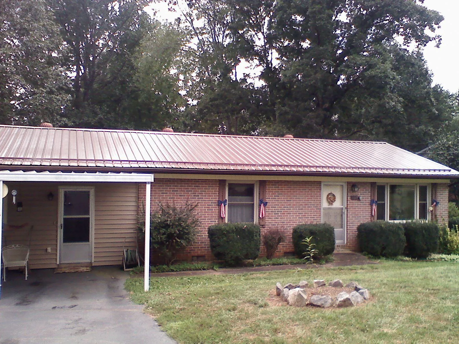 Bronze metal roof and carport on a brick ranch home — Roof Repair work by our crew in New Hope