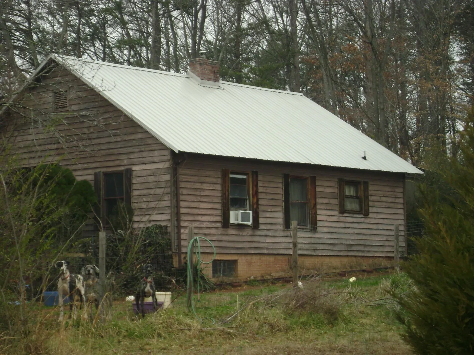 White metal roof on an old wood sided farmhouse, from a Metal Roof Installation job in New Hope